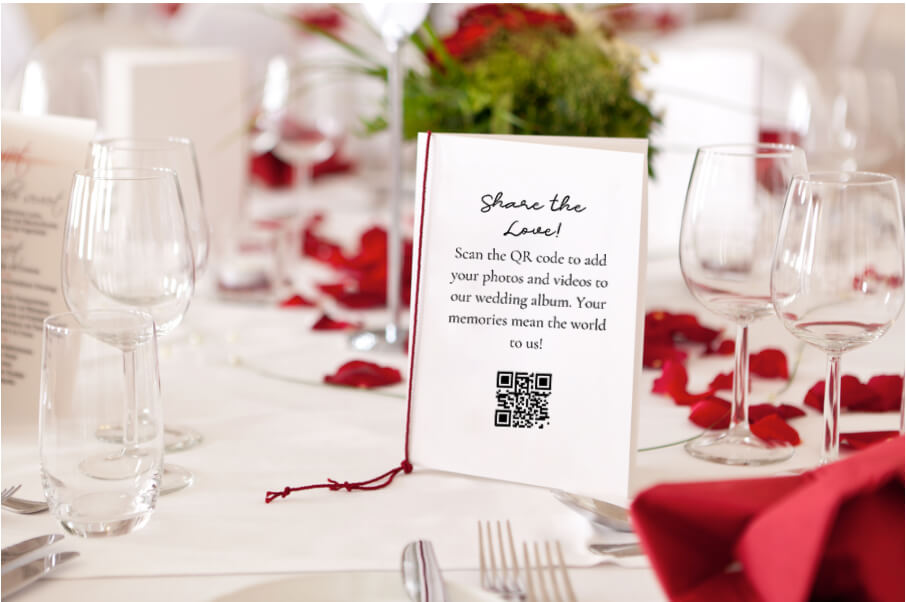 Table card showing a qr code for wedding photos at a reception place setting